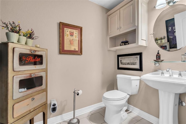 68 Ridgeview Rd, Ardmore, OK 73401 - bathroom with toilet, baseboards, and tile patterned floors