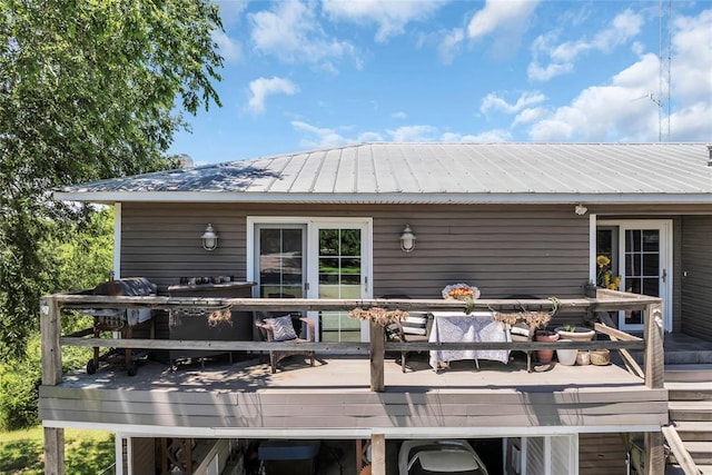 68 Ridgeview Rd, Ardmore, OK 73401 - rear view of property featuring a wooden deck, outdoor dining area, and metal roof