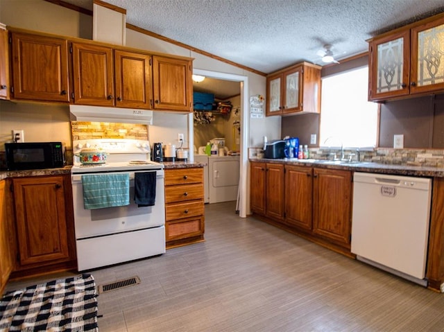 15026 N County Road 3370th Rd, Stratford, OK 74872 - kitchen featuring white appliances, under cabinet range hood, ornamental molding, brown cabinetry, and a sink