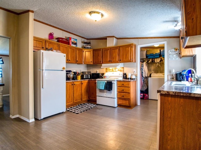 15026 N County Road 3370th Rd, Stratford, OK 74872 - kitchen featuring white appliances, a sink, under cabinet range hood, brown cabinets, and a textured ceiling