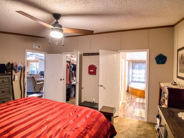 15026 N County Road 3370th Rd, Stratford, OK 74872 - bedroom with ornamental molding, a textured ceiling, a walk in closet, carpet, and ceiling fan