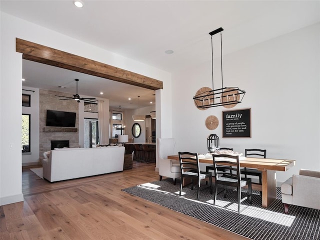 9117 SW 90th St, Mustang, OK 73064 - dining space with wood finished floors, a ceiling fan, beamed ceiling, a fireplace, and recessed lighting