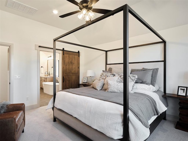 9117 SW 90th St, Mustang, OK 73064 - carpeted bedroom featuring a barn door, baseboards, ensuite bathroom, and ceiling fan