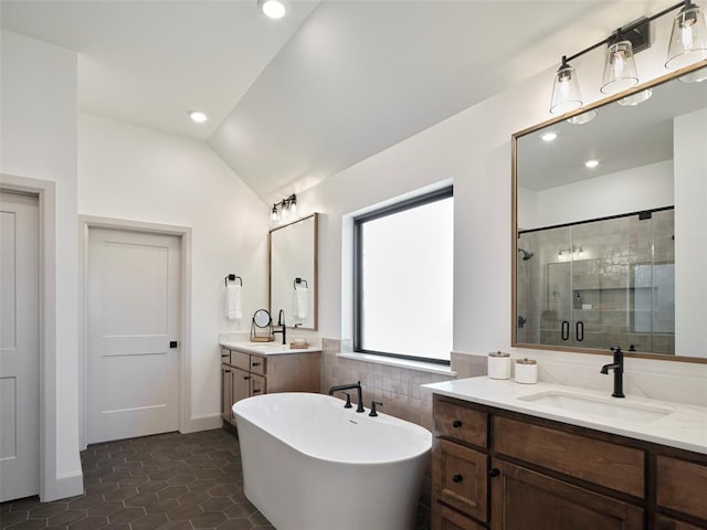 9117 SW 90th St, Mustang, OK 73064 - full bath featuring a shower stall, lofted ceiling, two vanities, a freestanding tub, and tile patterned flooring