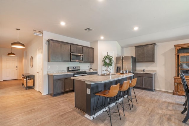 3429 Molly Dr, Yukon, OK 73099 - kitchen featuring appliances with stainless steel finishes, a sink, dark brown cabinets, light countertops, and recessed lighting
