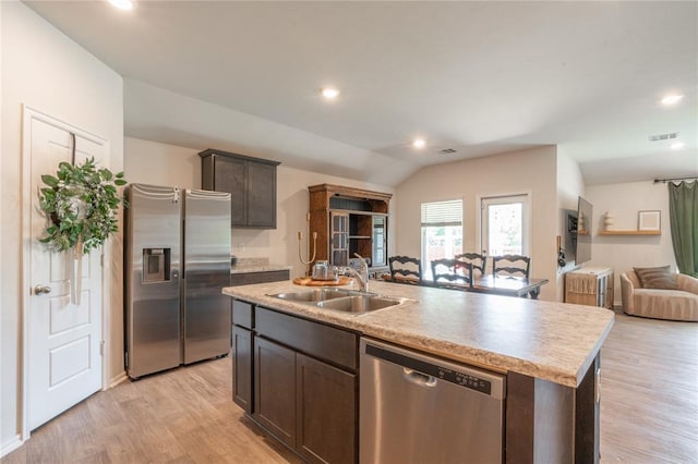 3429 Molly Dr, Yukon, OK 73099 - kitchen with stainless steel appliances, a sink, open floor plan, light wood-style flooring, and an island with sink