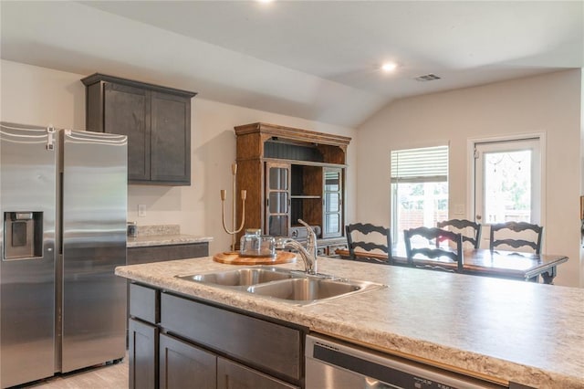 3429 Molly Dr, Yukon, OK 73099 - kitchen with appliances with stainless steel finishes, a sink, lofted ceiling, light countertops, and dark brown cabinetry