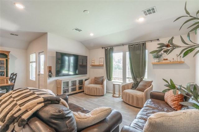 3429 Molly Dr, Yukon, OK 73099 - living area featuring vaulted ceiling, plenty of natural light, wood finished floors, and recessed lighting