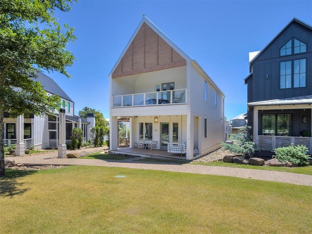 80 Pistache Ln, Carlton Landing, OK 74432 - back of house with a balcony, a yard, and board and batten siding
