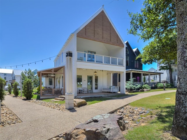 80 Pistache Ln, Carlton Landing, OK 74432 - back of house featuring a porch, a balcony, and a lawn