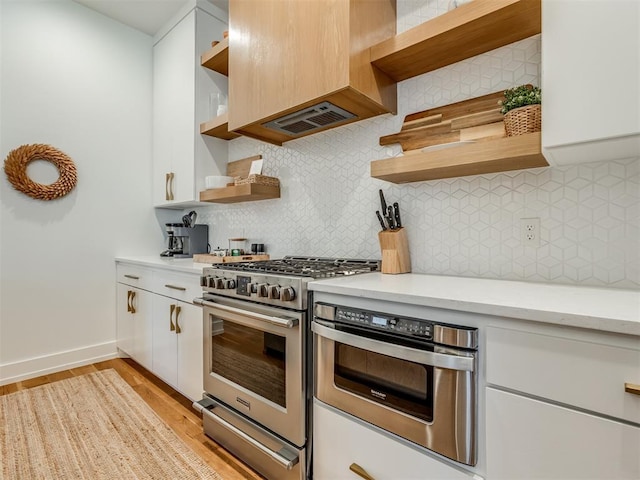 80 Pistache Ln, Carlton Landing, OK 74432 - kitchen featuring open shelves, stainless steel appliances, white cabinets, light wood finished floors, and decorative backsplash