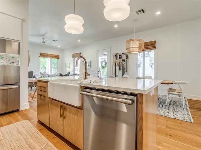 80 Pistache Ln, Carlton Landing, OK 74432 - kitchen featuring stainless steel appliances, a sink, light countertops, ceiling fan, and light wood finished floors