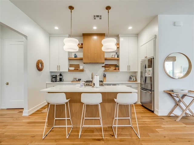 80 Pistache Ln, Carlton Landing, OK 74432 - kitchen with open shelves, stainless steel refrigerator with ice dispenser, light wood-style floors, a kitchen island, and recessed lighting