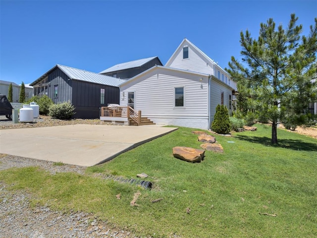 80 Pistache Ln, Carlton Landing, OK 74432 - rear view of house with a wooden deck, a lawn, and a patio area