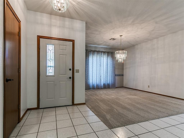 2601 Northwood Ln, Edmond, OK 73013 - foyer featuring a chandelier, light carpet, light tile patterned floors, and baseboards