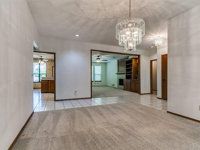 2601 Northwood Ln, Edmond, OK 73013 - unfurnished dining area featuring light tile patterned floors, ceiling fan, light carpet, a chandelier, and baseboards
