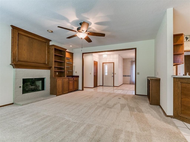2601 Northwood Ln, Edmond, OK 73013 - unfurnished living room featuring a ceiling fan, light carpet, baseboards, and light tile patterned floors