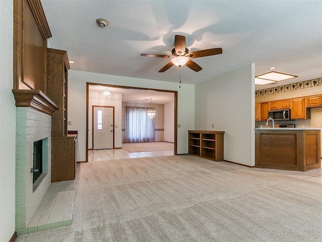 2601 Northwood Ln, Edmond, OK 73013 - unfurnished living room with light carpet, a brick fireplace, a ceiling fan, light tile patterned floors, and recessed lighting