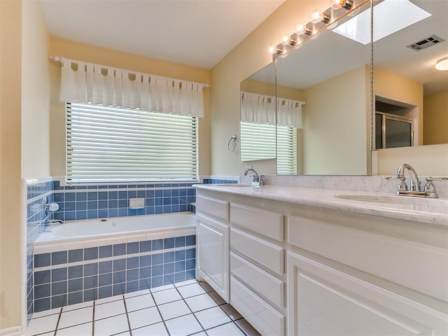 2601 Northwood Ln, Edmond, OK 73013 - full bathroom featuring a garden tub, double vanity, tile patterned floors, and plenty of natural light
