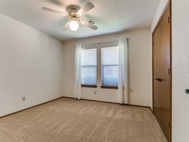 2601 Northwood Ln, Edmond, OK 73013 - spare room featuring light colored carpet, a ceiling fan, and baseboards