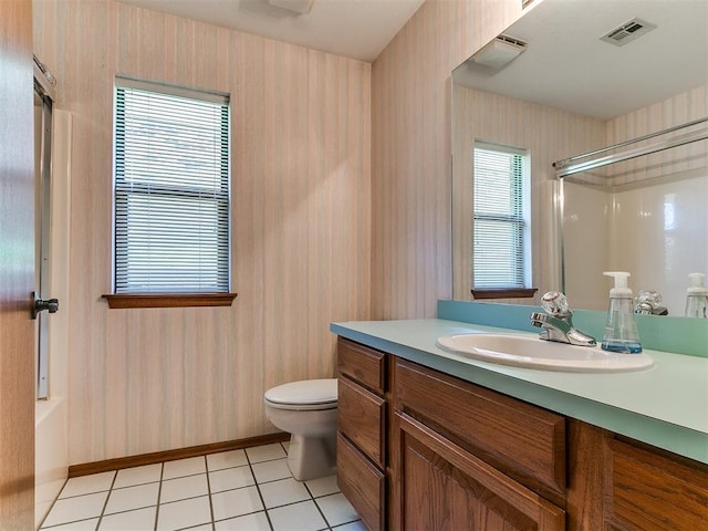 2601 Northwood Ln, Edmond, OK 73013 - bathroom with wallpapered walls, a shower with shower door, vanity, toilet, and tile patterned floors