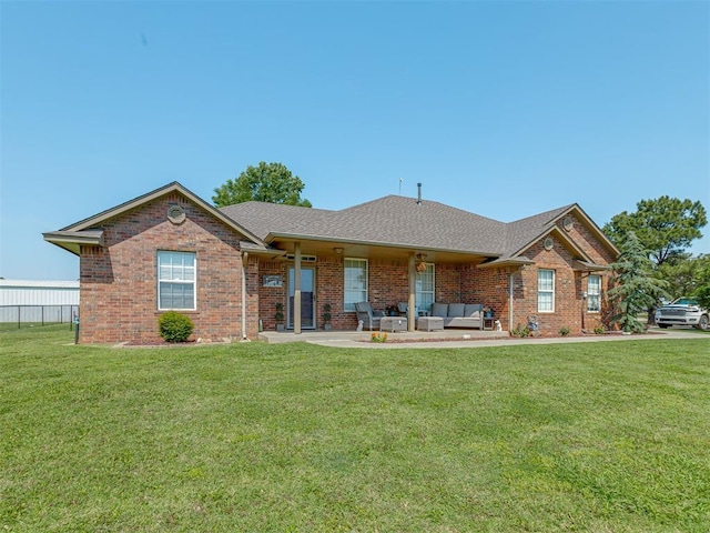 846 County St Unit 2910, Tuttle, OK 73089 - view of front of property with outdoor lounge area, a front yard, brick siding, and a patio