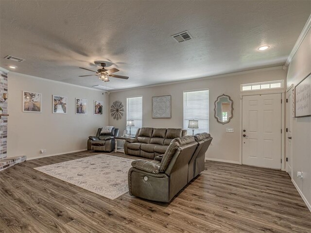 846 County St Unit 2910, Tuttle, OK 73089 - living area with wood finished floors, ceiling fan, a textured ceiling, crown molding, and baseboards