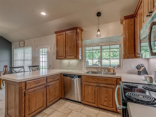 846 County St Unit 2910, Tuttle, OK 73089 - kitchen featuring appliances with stainless steel finishes, a sink, a peninsula, brown cabinets, and stone tile floors