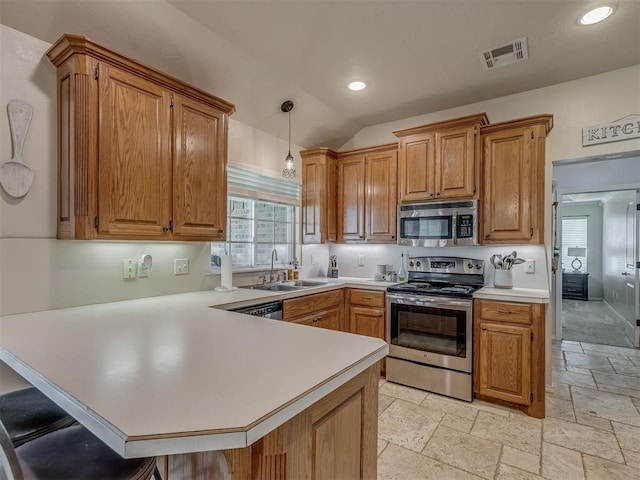 846 County St Unit 2910, Tuttle, OK 73089 - kitchen featuring stainless steel appliances, a sink, a peninsula, stone tile flooring, and light countertops