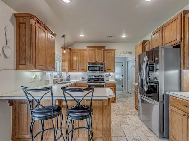 846 County St Unit 2910, Tuttle, OK 73089 - kitchen featuring appliances with stainless steel finishes, a sink, a peninsula, stone tile floors, and recessed lighting