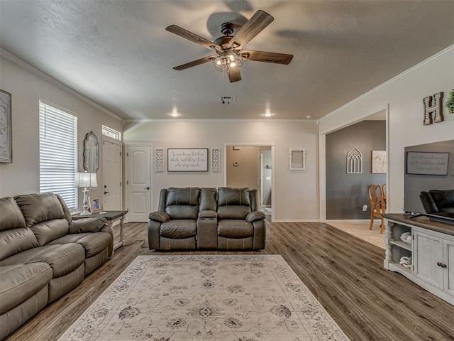 846 County St Unit 2910, Tuttle, OK 73089 - living area featuring wood finished floors, ceiling fan, crown molding, baseboards, and a textured ceiling