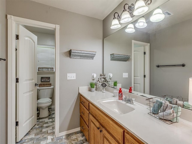 846 County St Unit 2910, Tuttle, OK 73089 - bathroom with vanity, toilet, a chandelier, and baseboards