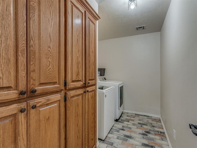 846 County St Unit 2910, Tuttle, OK 73089 - laundry room with washer and dryer, baseboards, brick floors, and cabinet space