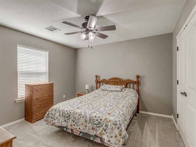 846 County St Unit 2910, Tuttle, OK 73089 - bedroom featuring light colored carpet, a closet, baseboards, ceiling fan, and a textured ceiling