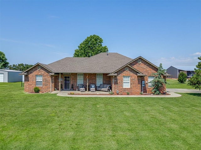 846 County St Unit 2910, Tuttle, OK 73089 - view of front of property with a front lawn, brick siding, a shingled roof, and outdoor lounge area