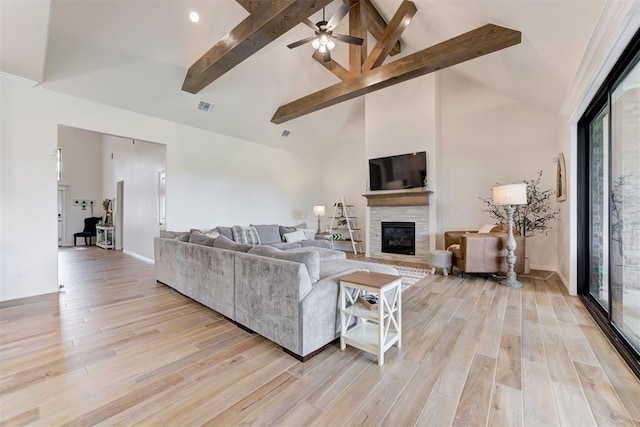 5804 NW 159th St, Edmond, OK 73013 - living room with a fireplace, beam ceiling, light wood finished floors, ceiling fan, and high vaulted ceiling