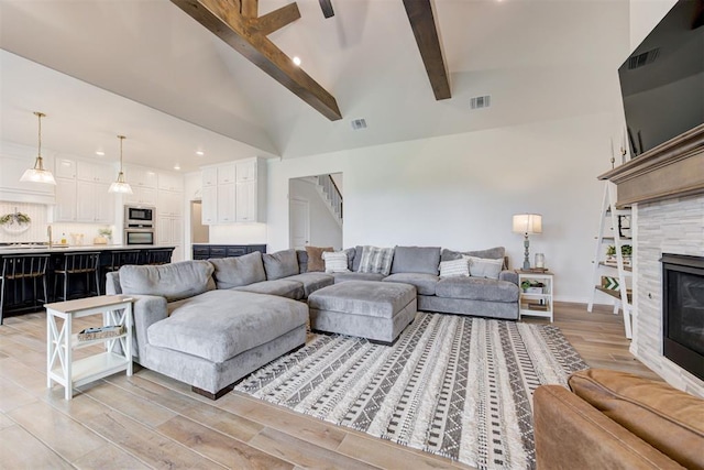 5804 NW 159th St, Edmond, OK 73013 - living area featuring beamed ceiling, light wood-type flooring, recessed lighting, a fireplace, and high vaulted ceiling