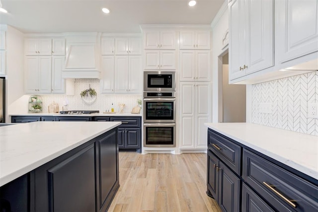 5804 NW 159th St, Edmond, OK 73013 - kitchen featuring white cabinetry, custom exhaust hood, recessed lighting, appliances with stainless steel finishes, and decorative backsplash