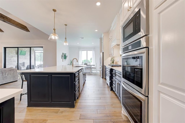 5804 NW 159th St, Edmond, OK 73013 - kitchen with appliances with stainless steel finishes, dark cabinetry, open floor plan, light countertops, and white cabinetry