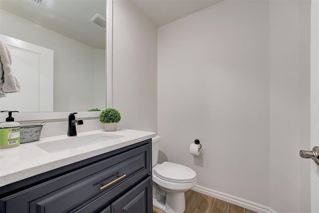 5804 NW 159th St, Edmond, OK 73013 - bathroom featuring wood finished floors, toilet, vanity, and baseboards