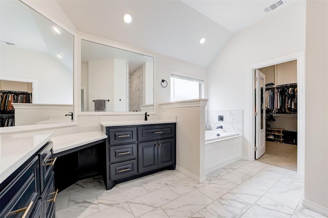 5804 NW 159th St, Edmond, OK 73013 - full bath featuring two vanities, a garden tub, marble look tiles, a walk in closet, and lofted ceiling