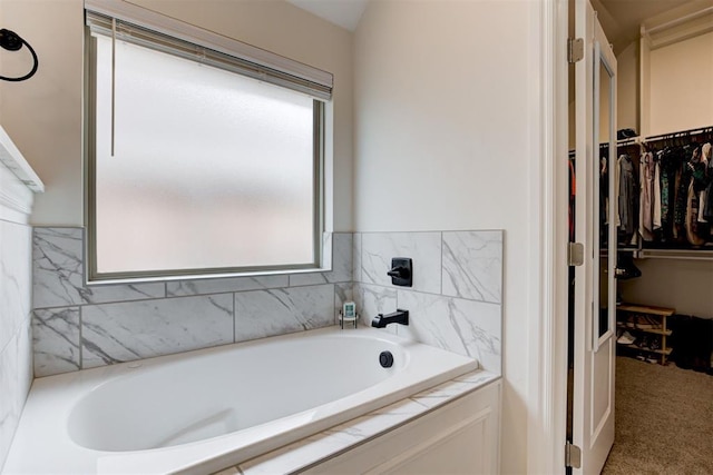 5804 NW 159th St, Edmond, OK 73013 - bathroom featuring a garden tub and a walk in closet