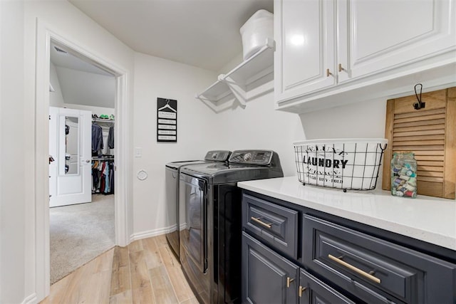 5804 NW 159th St, Edmond, OK 73013 - laundry room featuring cabinet space, washer and clothes dryer, light wood-style floors, and baseboards