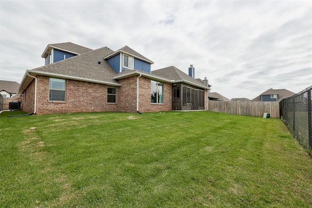 5804 NW 159th St, Edmond, OK 73013 - rear view of house with central AC unit, roof with shingles, brick siding, and a sunroom