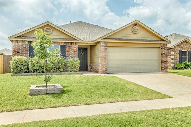 5318 Kye Dr, Tuttle, OK 73089 - view of front facade with brick siding, an attached garage, driveway, and a shingled roof
