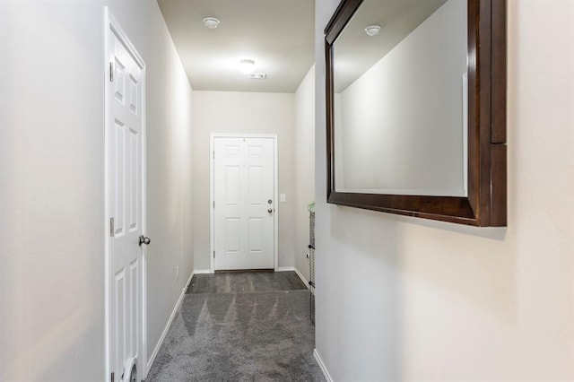5318 Kye Dr, Tuttle, OK 73089 - hallway with dark carpet and baseboards