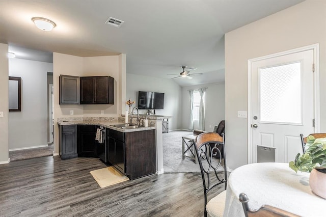 5318 Kye Dr, Tuttle, OK 73089 - kitchen with a sink, dark wood-style floors, a peninsula, baseboards, and ceiling fan