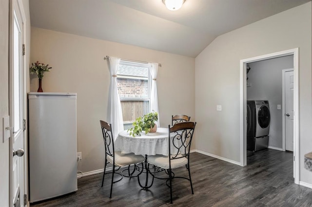5318 Kye Dr, Tuttle, OK 73089 - dining room featuring washing machine and dryer, dark wood finished floors, lofted ceiling, and baseboards