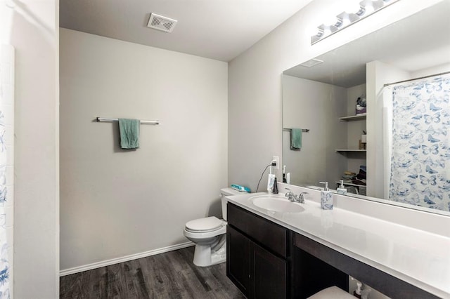 5318 Kye Dr, Tuttle, OK 73089 - full bathroom with wood finished floors, toilet, vanity, baseboards, and a shower with curtain