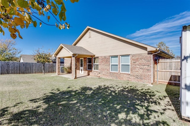 9520 SW 24th Ter, Oklahoma City, OK 73128 - back of house featuring a patio area and brick siding